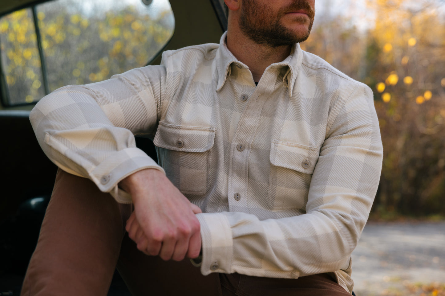 Man wearing a tan plaid Six Season flannel shirt by Warren.