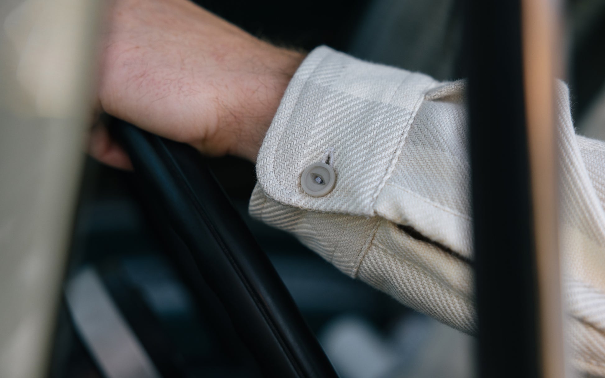 Close up of a man wearing a tan plaid Six Season flannel shirt by Warren.